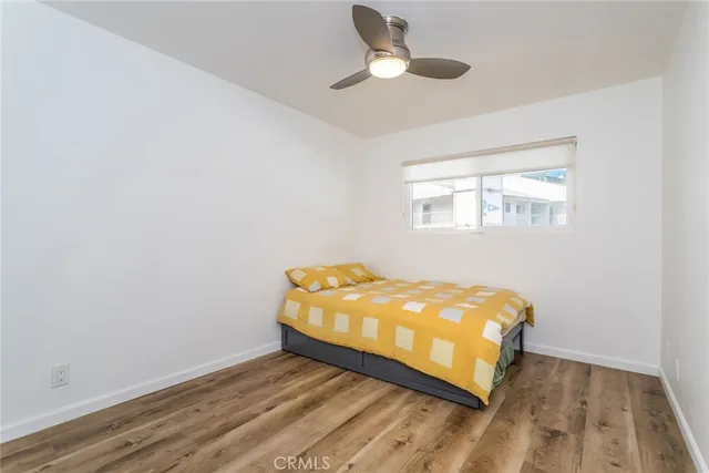 an empty room with a bed and a window