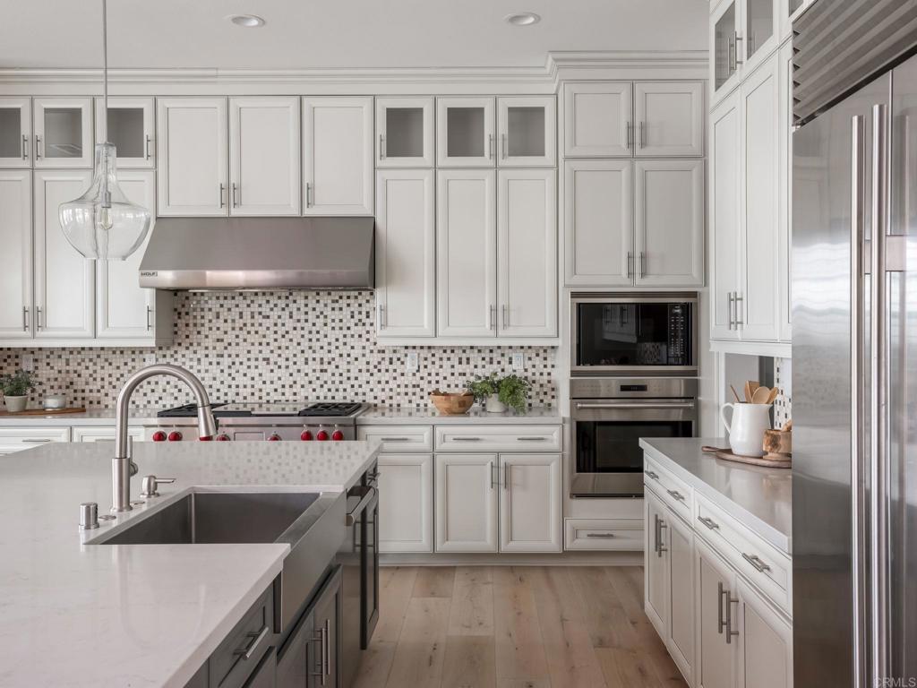 546 Ledge Street San Marcos, CA 92078 - Photo 13 of 75 a kitchen with stainless steel appliances granite countertop a sink stove and refrigerator