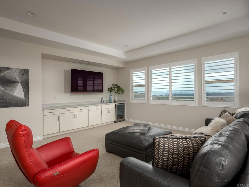 546 Ledge Street San Marcos, CA 92078 - Photo 38 of 75 a living room with furniture a flat screen tv and a window