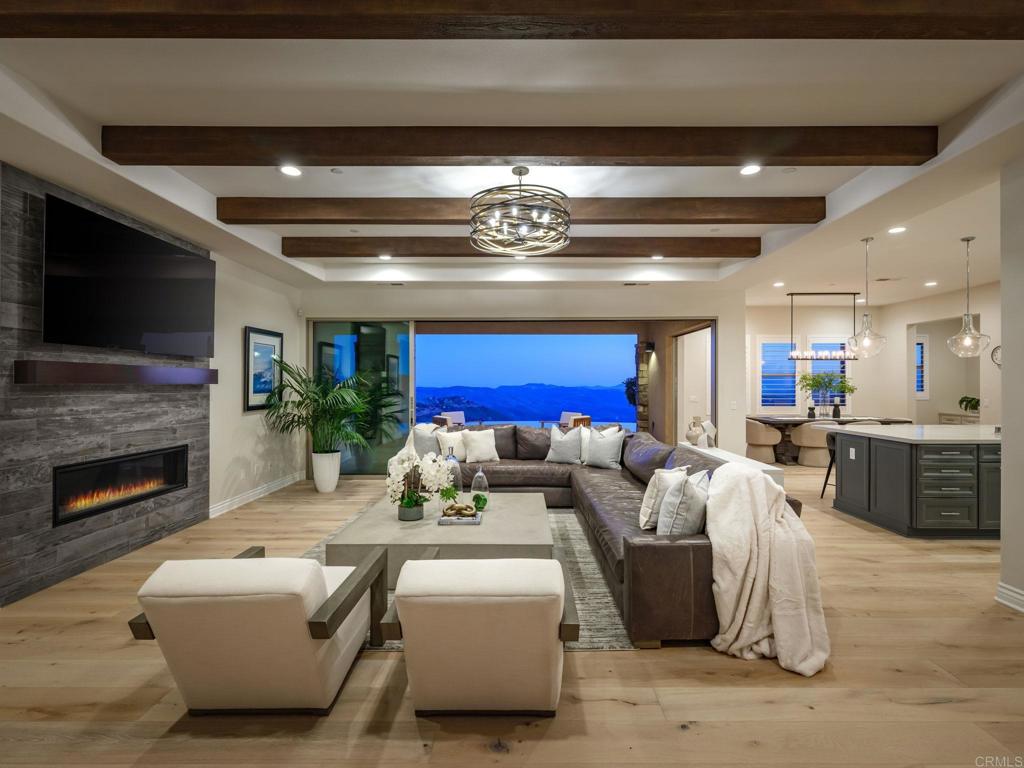 546 Ledge Street San Marcos, CA 92078 - Photo 60 of 75 a living room with furniture a fireplace and a flat screen tv