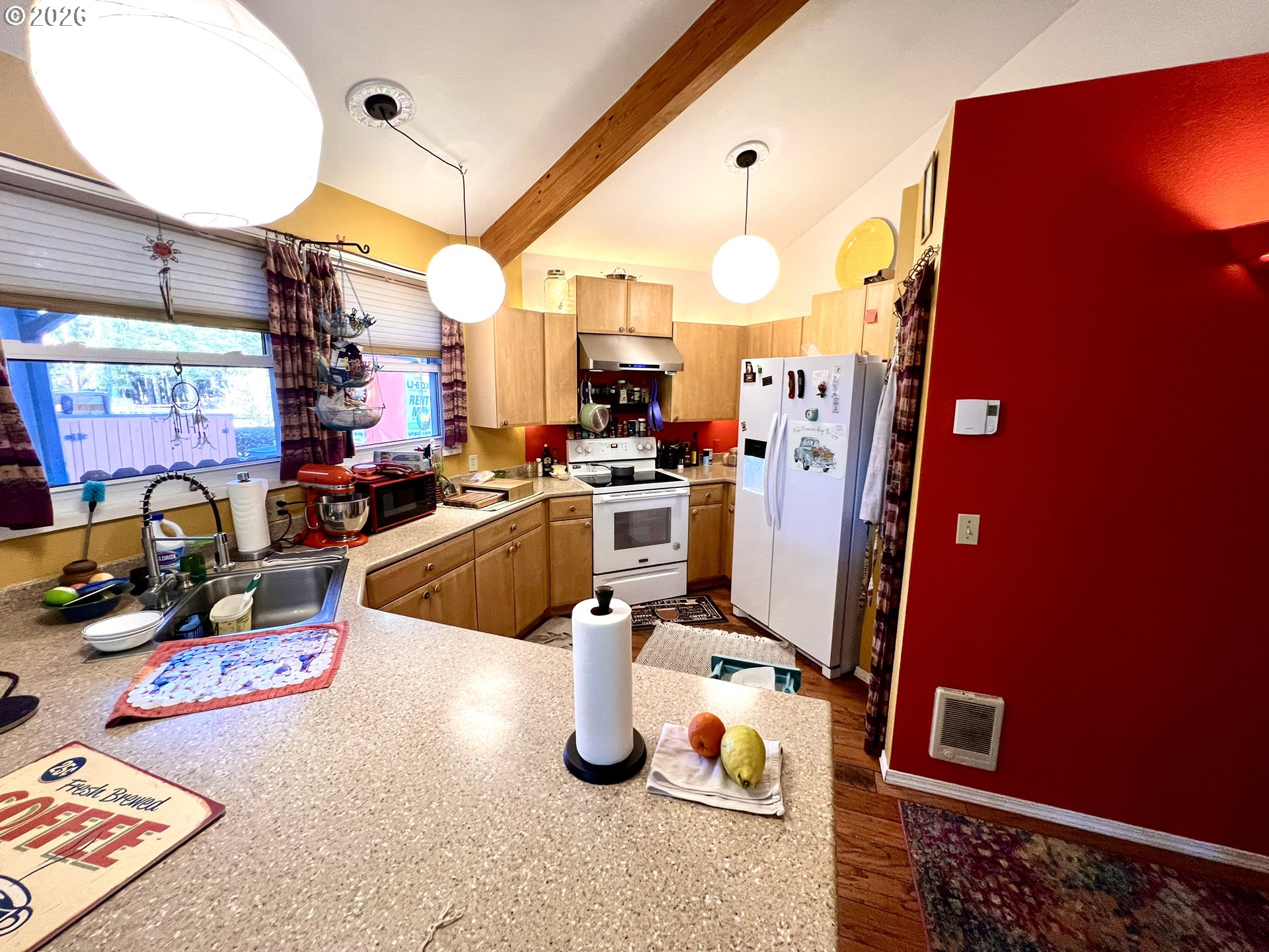 1625 Kristi Loop Lakeside, OR 97449 - Photo 13 of 41 a kitchen with stainless steel appliances granite countertop a sink dishwasher and a stove with wooden floor
