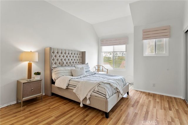 a bedroom with a bed and large mirror