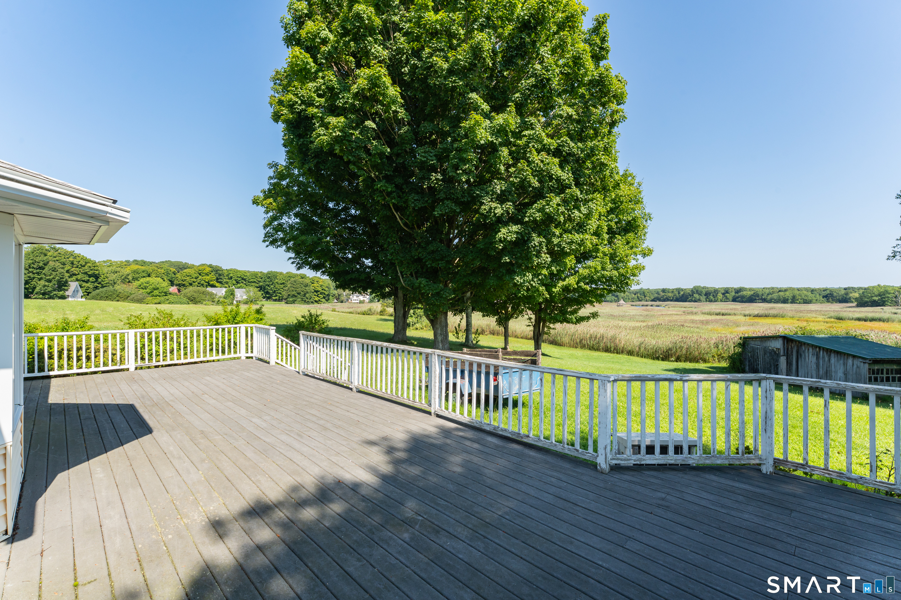118 River Road Madison, CT 06443 - Photo 7 of 25 The deck goes across the entire rear of the house.