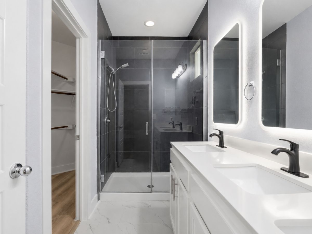 7208 Lysander Court Austin, TX 78741 - Photo 10 of 15 a bathroom with a double vanity sink mirror and shower