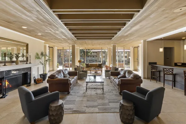 a living room with furniture and a floor to ceiling window