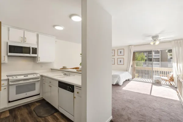 a kitchen with a sink a microwave and cabinets