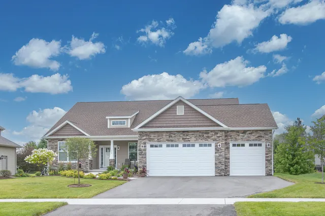 a front view of a house with a yard and garage