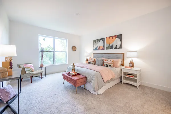 a bedroom with a bed and a couch