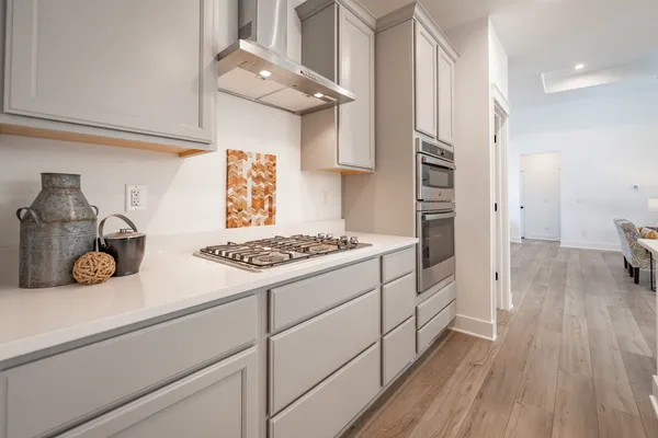 a kitchen with a sink and a stove top oven