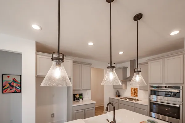 a kitchen with stainless steel appliances a stove a sink and a window