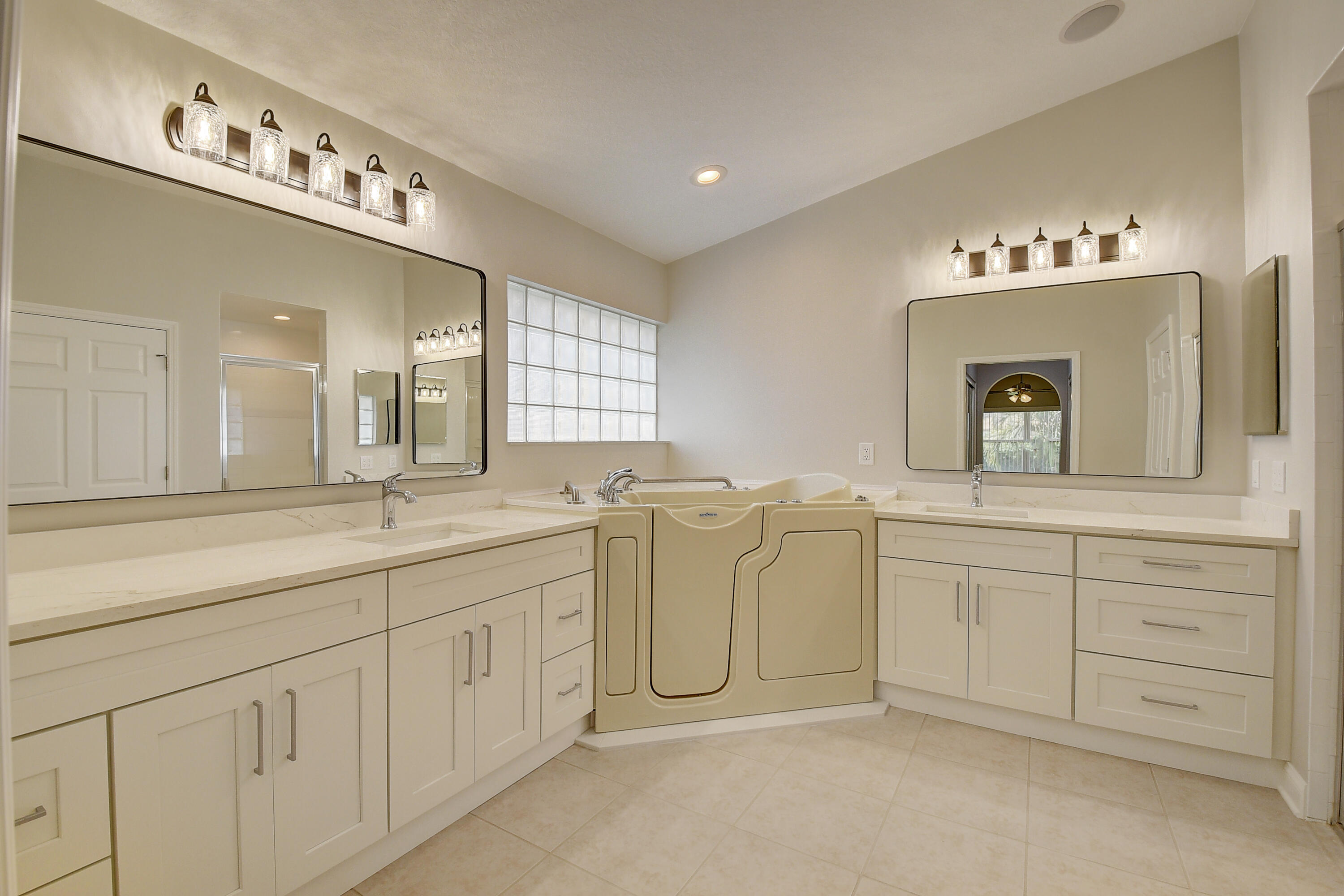6670 Maybrook Road Boynton Beach, FL 33437 - Photo 14 of 72 a spacious bathroom with a double vanity sink and mirror