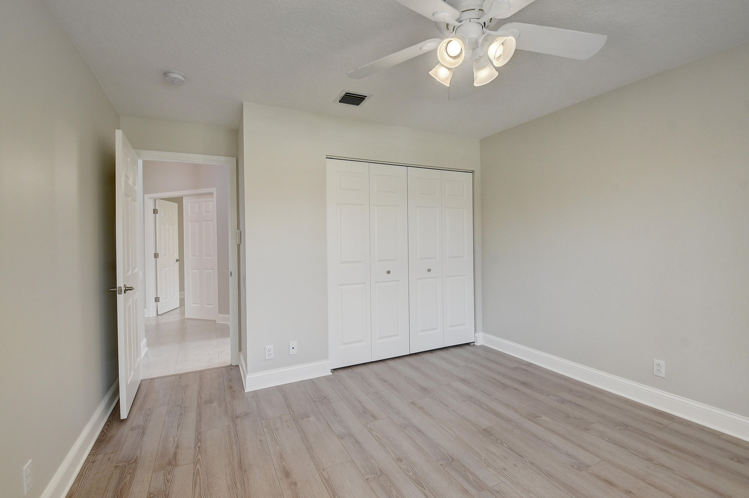 6670 Maybrook Road Boynton Beach, FL 33437 - Photo 19 of 72 a view of an empty room with wooden floor