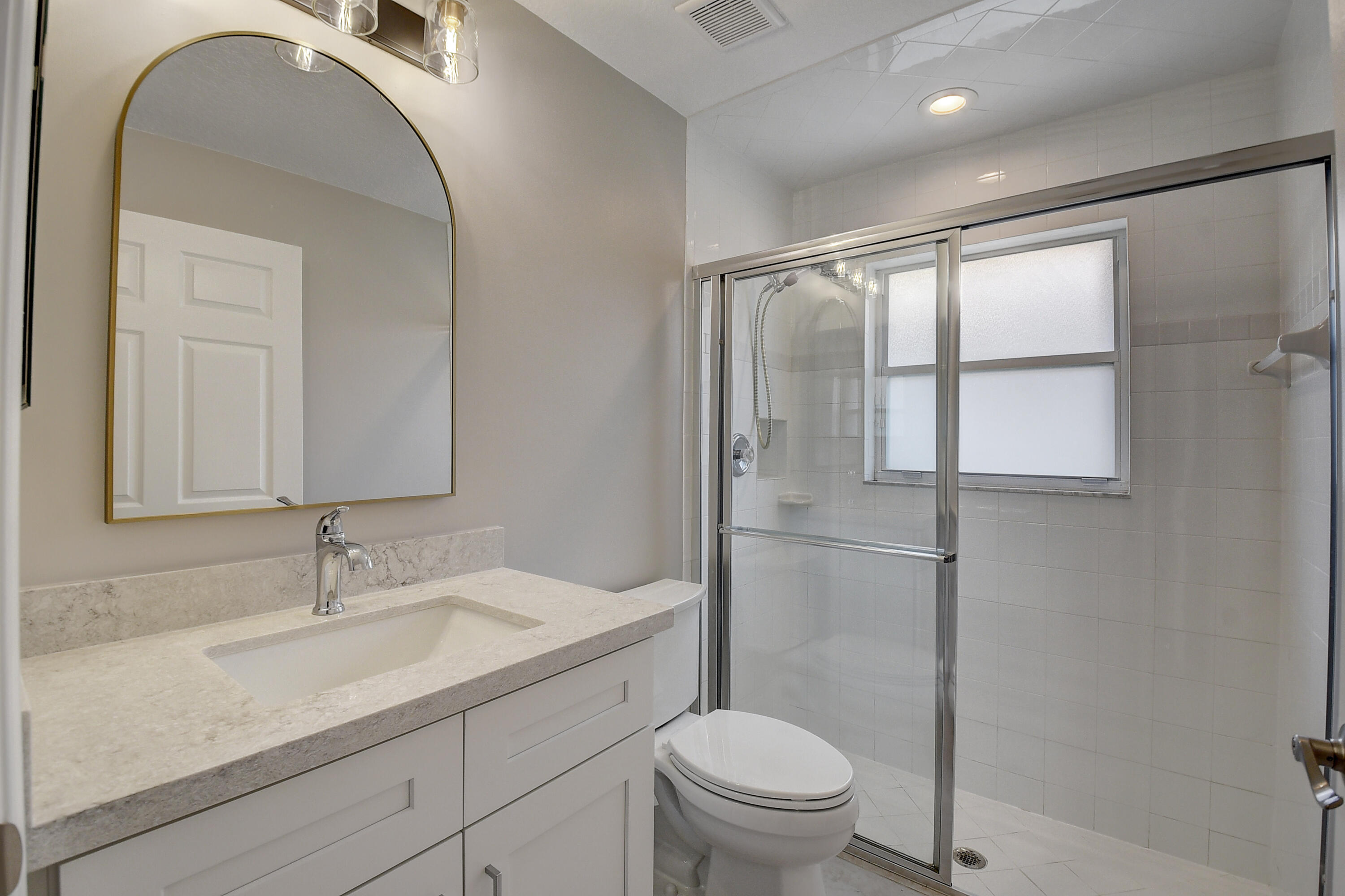 6670 Maybrook Road Boynton Beach, FL 33437 - Photo 20 of 72 a bathroom with a sink a toilet and shower