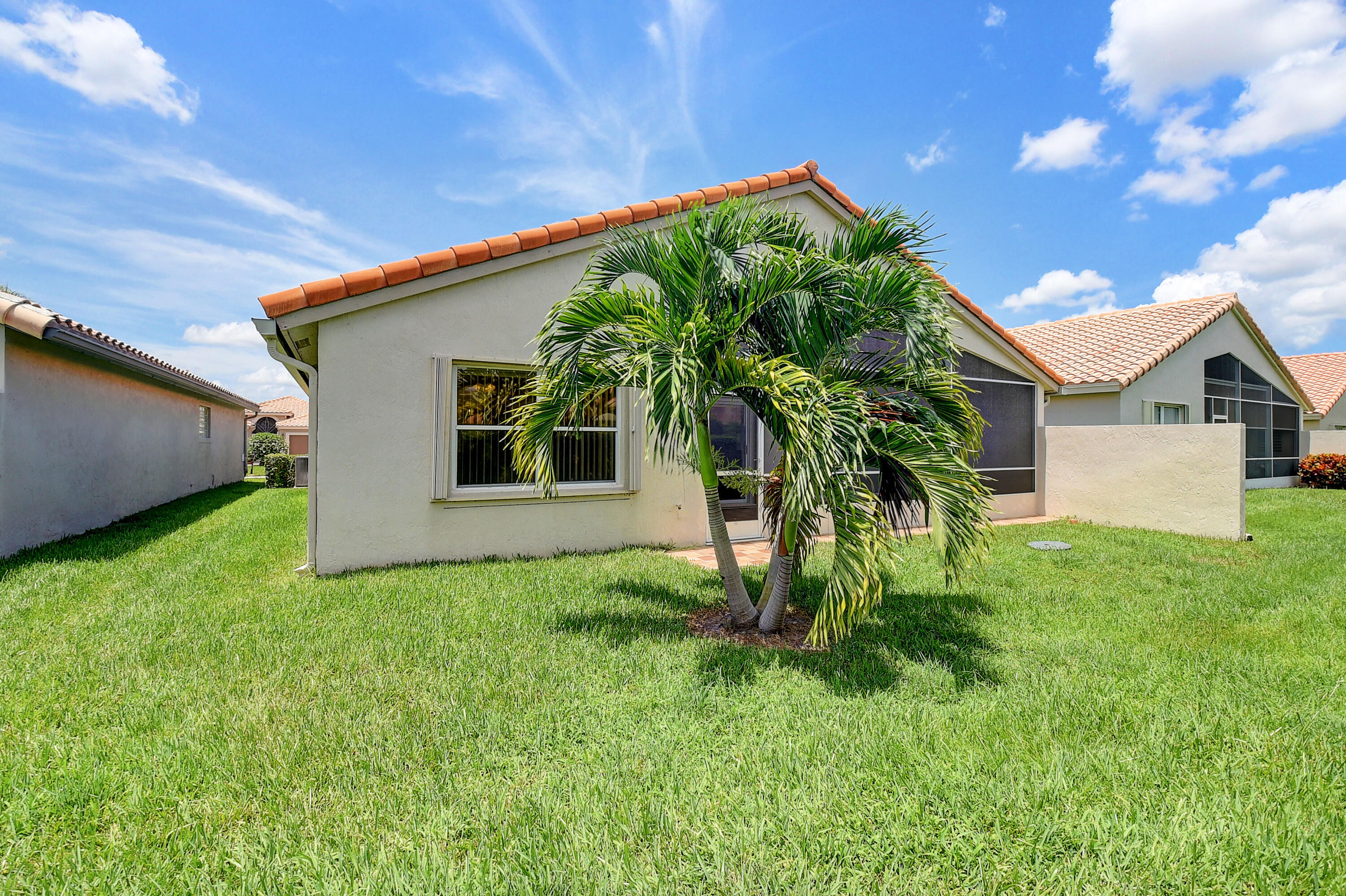 6670 Maybrook Road Boynton Beach, FL 33437 - Photo 29 of 72 a front view of a house with a yard