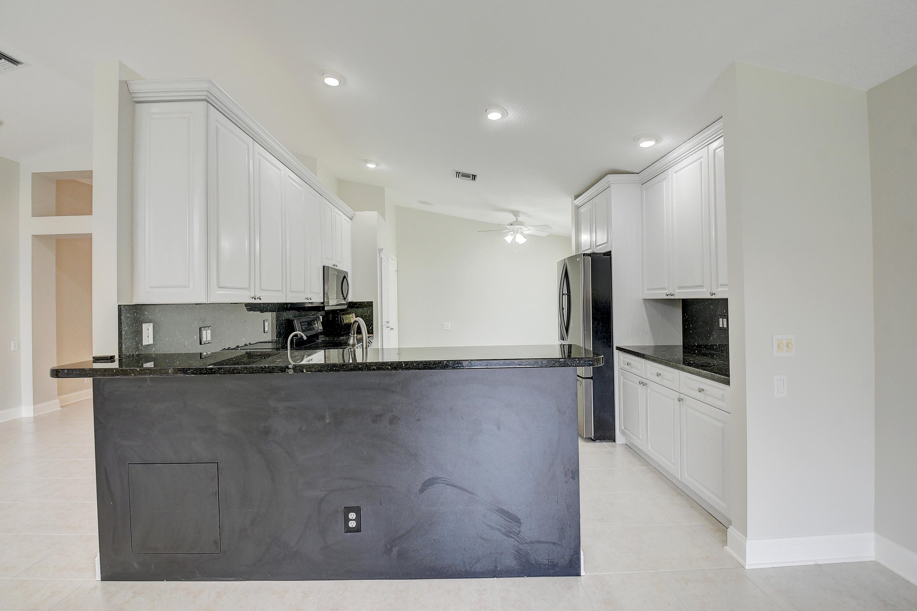 6670 Maybrook Road Boynton Beach, FL 33437 - Photo 5 of 72 a kitchen with stainless steel appliances granite countertop a refrigerator a stove and a sink