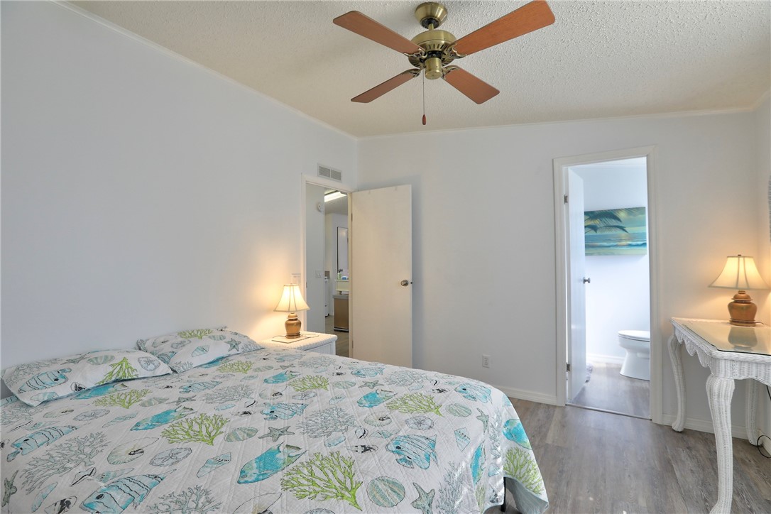 7576 Chasta Road Micco, FL 32976 - Photo 11 of 27 a bedroom with a bed and a chandelier