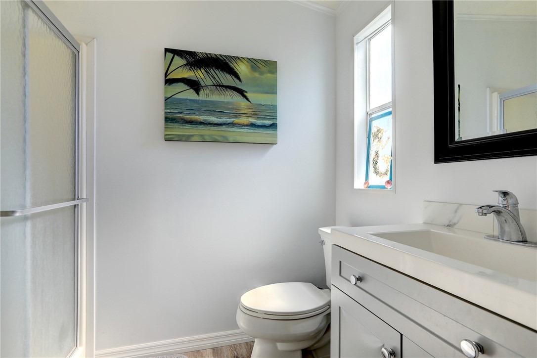 7576 Chasta Road Micco, FL 32976 - Photo 12 of 27 a bathroom with a toilet a sink and a window