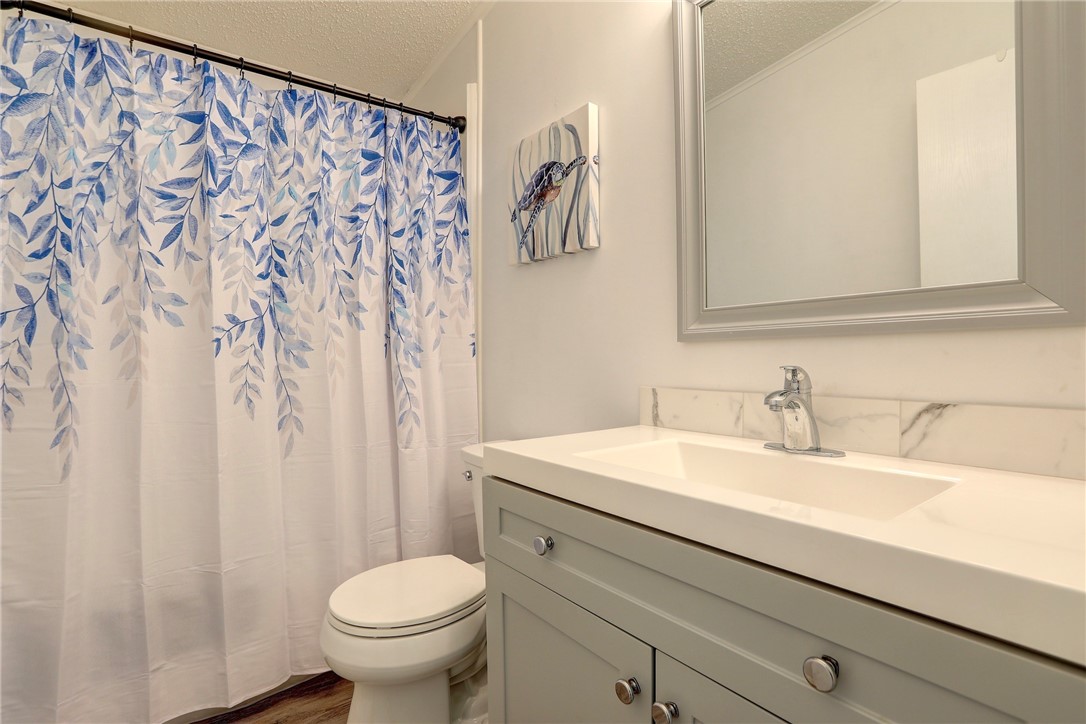 7576 Chasta Road Micco, FL 32976 - Photo 15 of 27 a bathroom with a sink and a toilet
