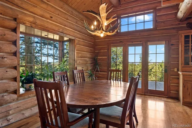 a dining room with furniture wooden floor and a potted plant