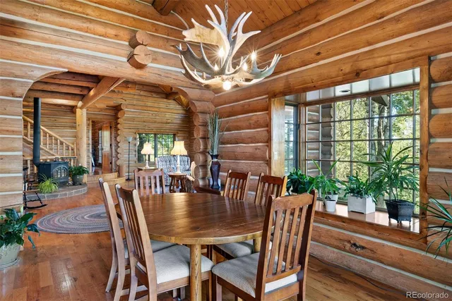 a dining room with furniture a chandelier and window