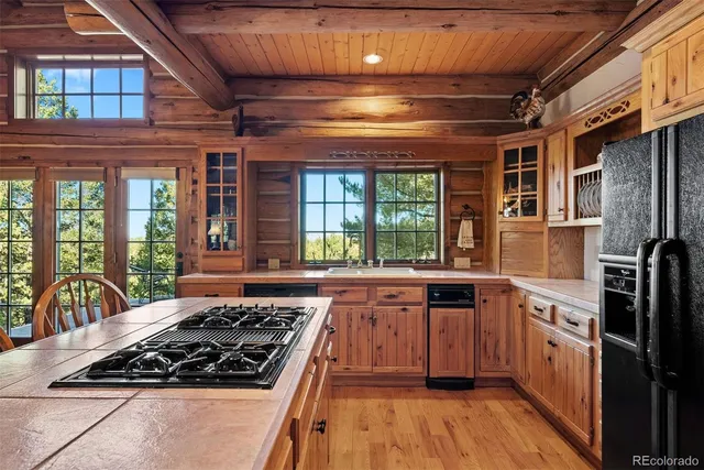a kitchen with stainless steel appliances a stove a sink and a refrigerator