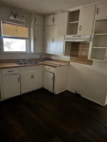 a kitchen with a sink and cabinets