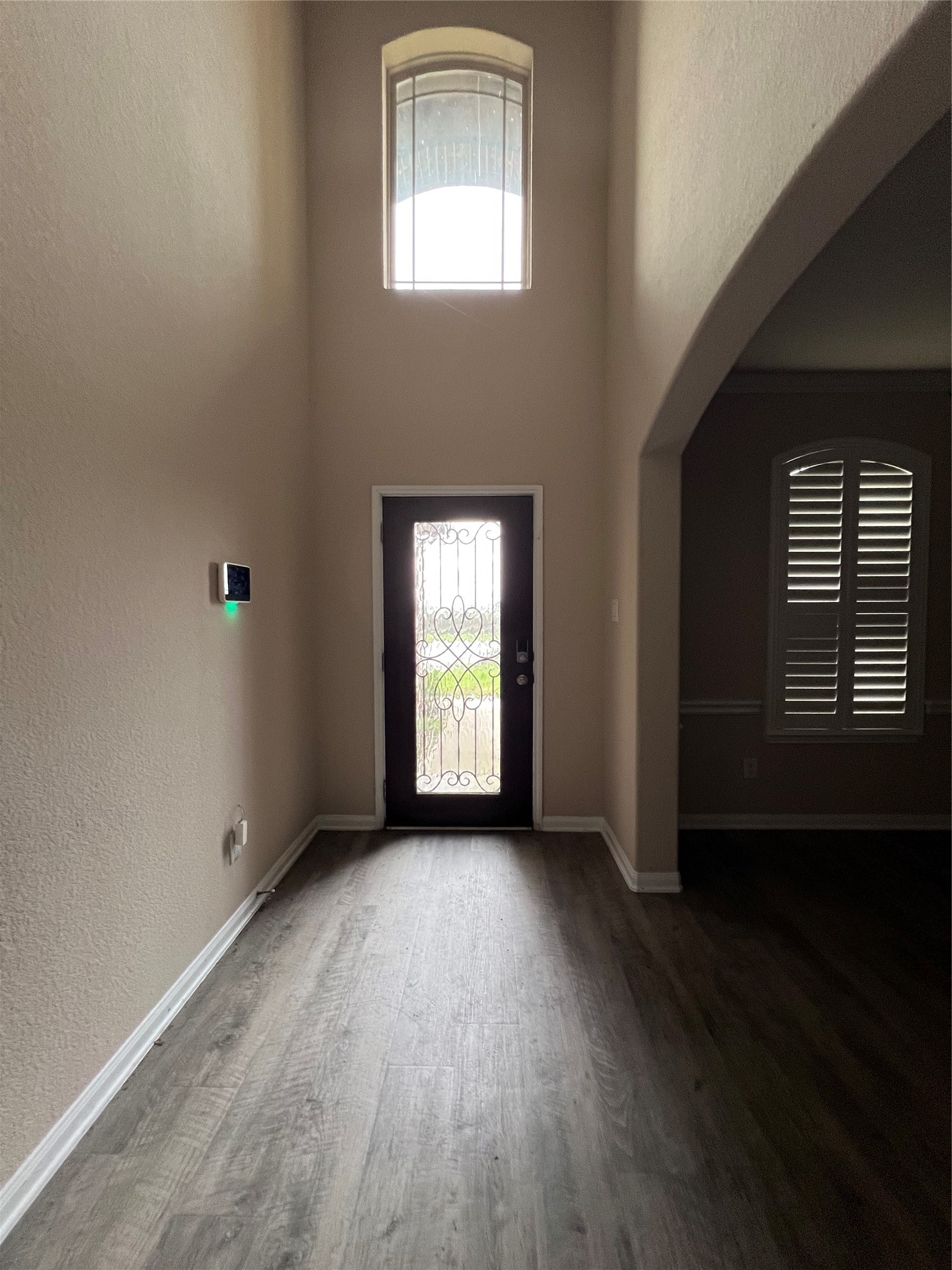 7703 Lehman Road Beasley, TX 77417 - Photo 5 of 17 a view of an empty room with wooden floor and a window