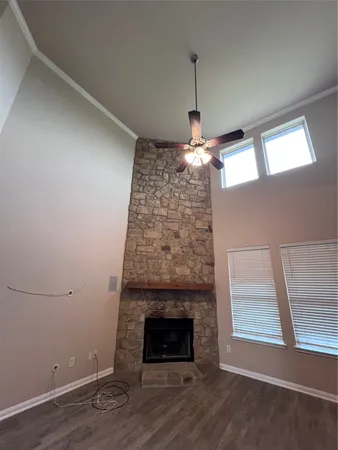 an empty room with a fireplace and window