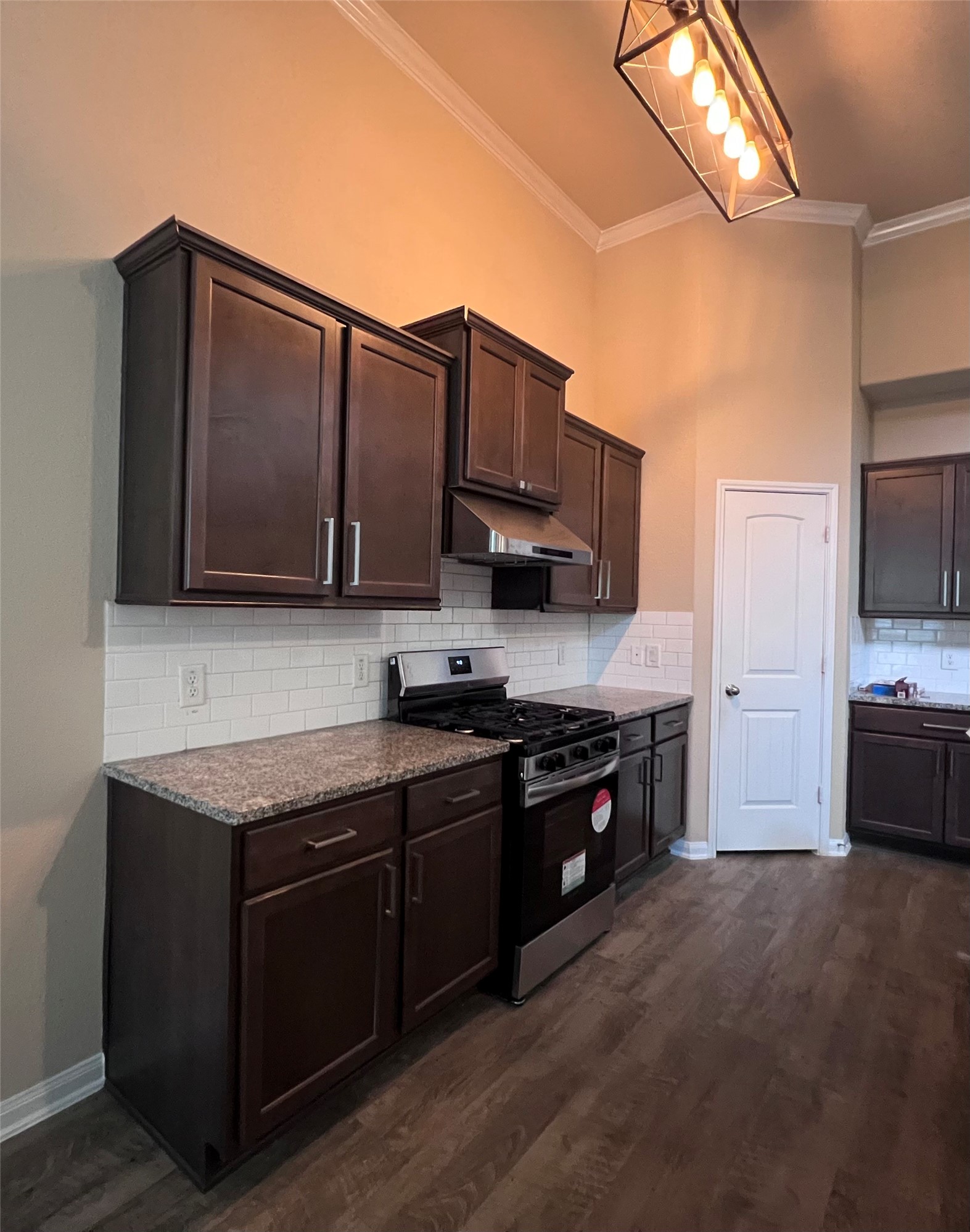 7703 Lehman Road Beasley, TX 77417 - Photo 7 of 17 a kitchen with stainless steel appliances granite countertop a stove a sink and a microwave
