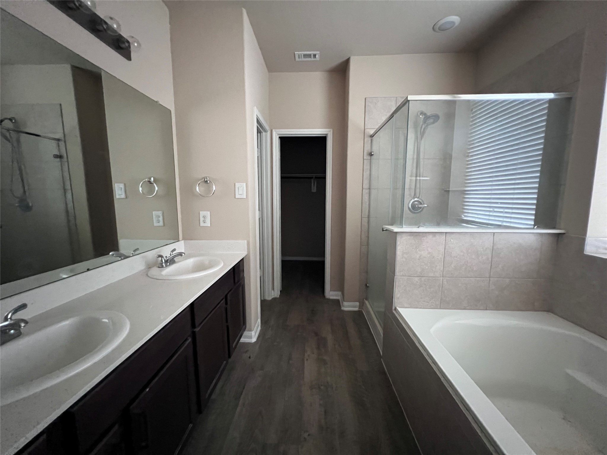 7703 Lehman Road Beasley, TX 77417 - Photo 9 of 17 a bathroom with a tub sink shower and two mirror
