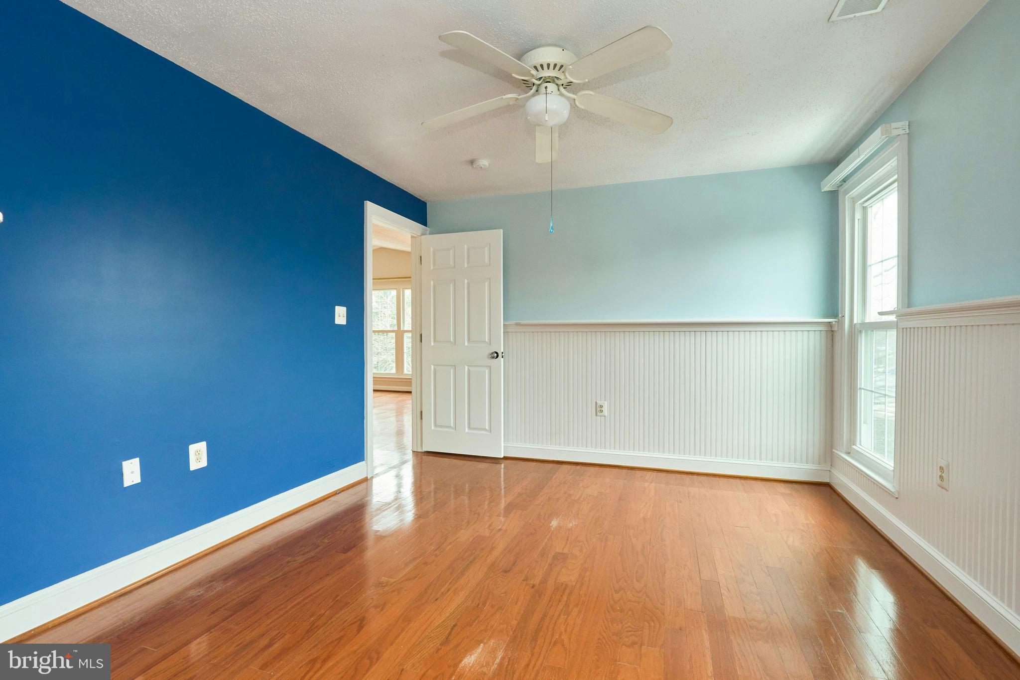 21014 Timber Ridge Terrace, Unit 302 Ashburn, VA 20147 - Photo 11 of 32 wooden floor in an empty room with a window