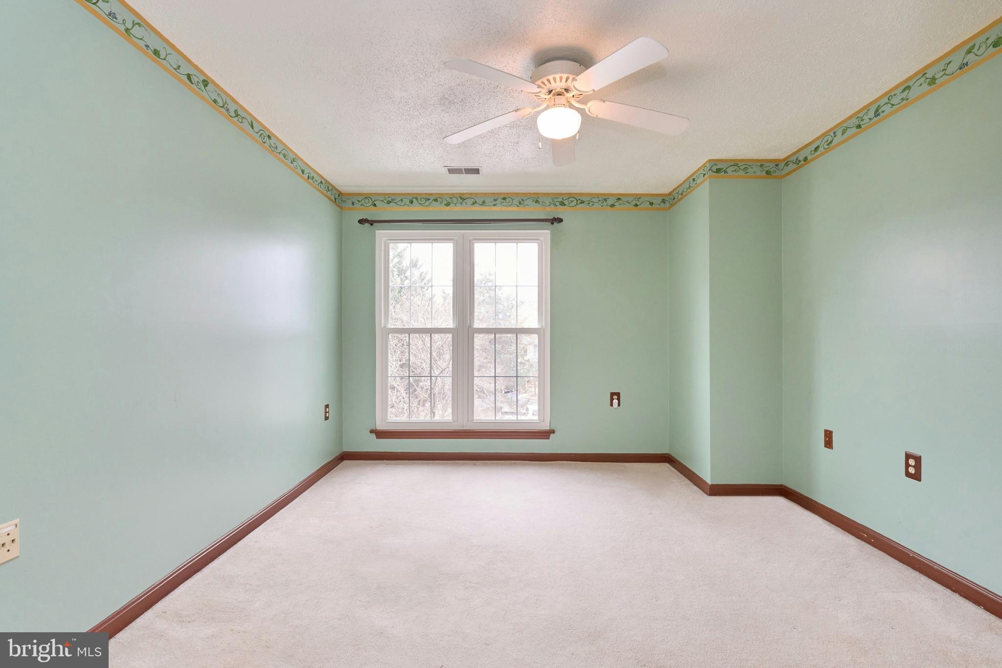 21014 Timber Ridge Terrace, Unit 302 Ashburn, VA 20147 - Photo 12 of 32 an empty room with windows and fan