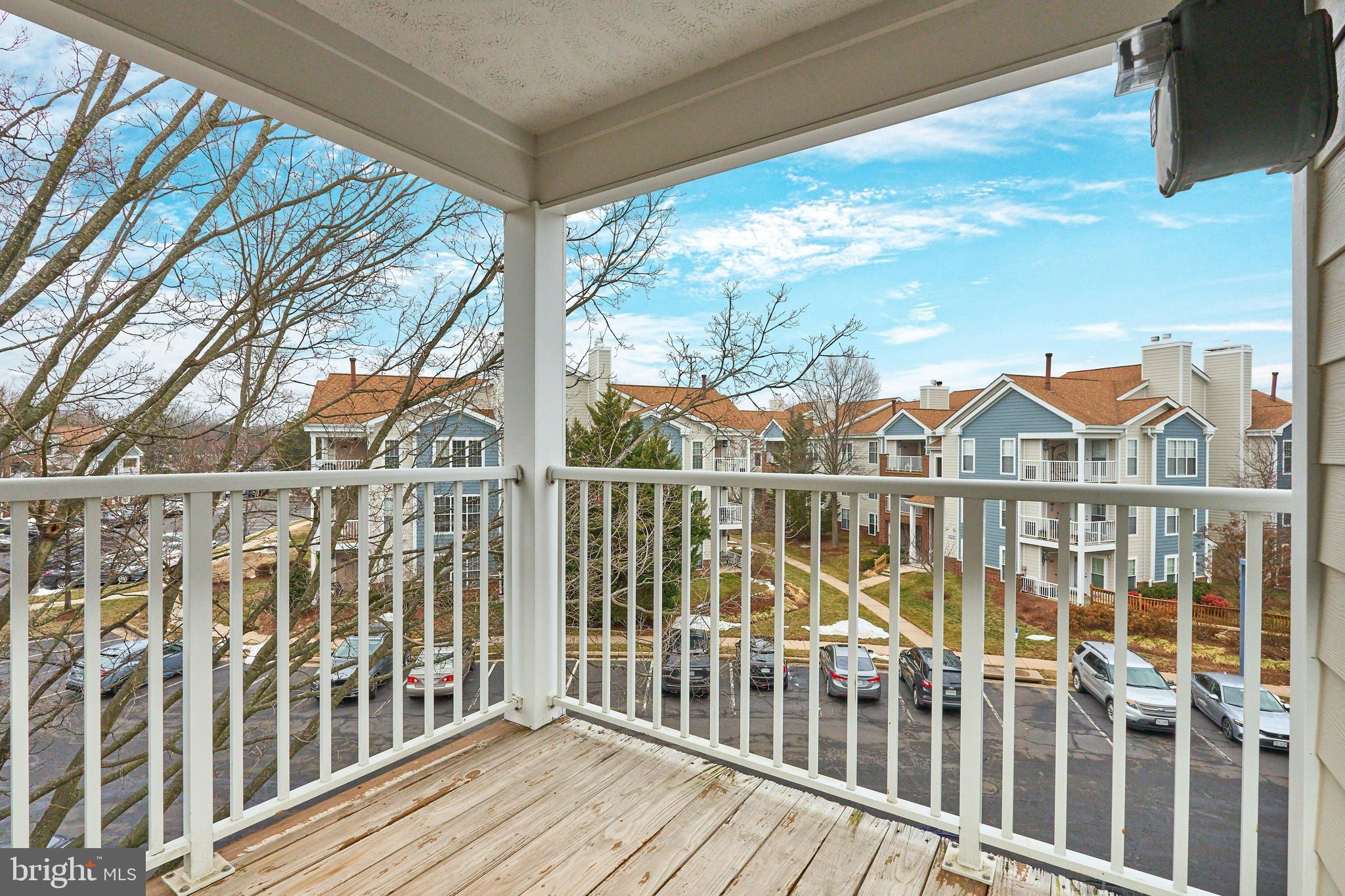 21014 Timber Ridge Terrace, Unit 302 Ashburn, VA 20147 - Photo 19 of 32 a view of a balcony with wooden floor