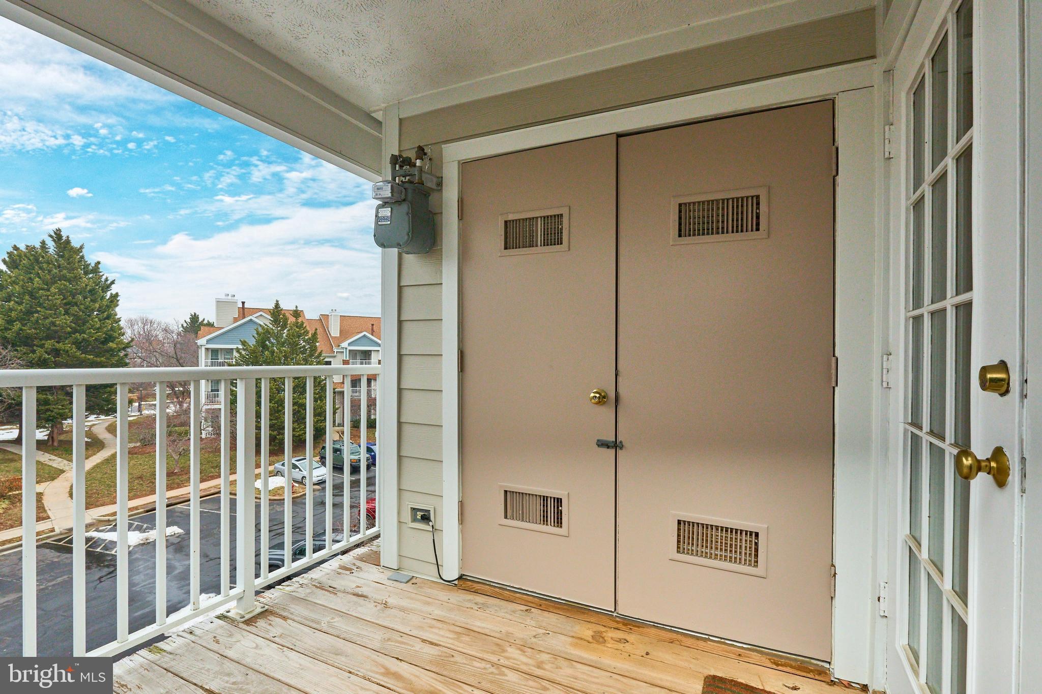 21014 Timber Ridge Terrace, Unit 302 Ashburn, VA 20147 - Photo 20 of 32 a view of a balcony with wooden floor