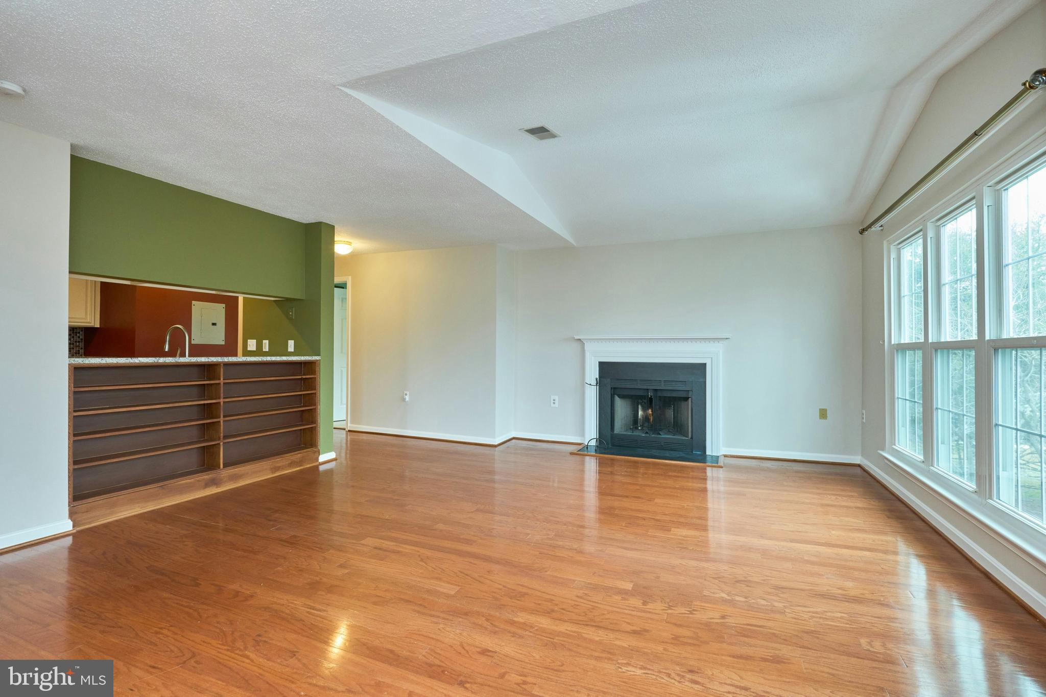 21014 Timber Ridge Terrace, Unit 302 Ashburn, VA 20147 - Photo 24 of 32 a view of an empty room with a window and wooden floor