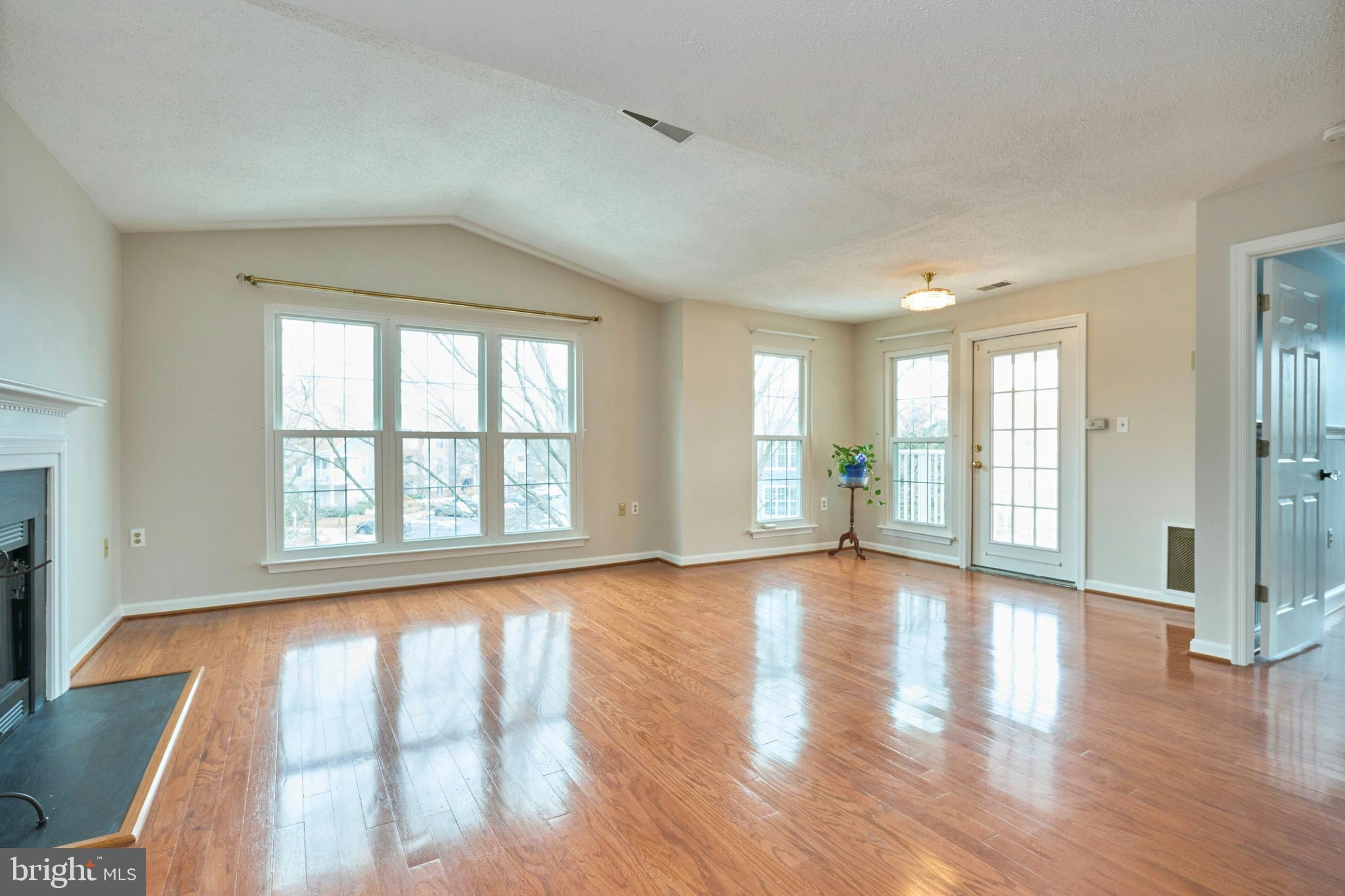 21014 Timber Ridge Terrace, Unit 302 Ashburn, VA 20147 - Photo 25 of 32 a view of an empty room with wooden floor and a window