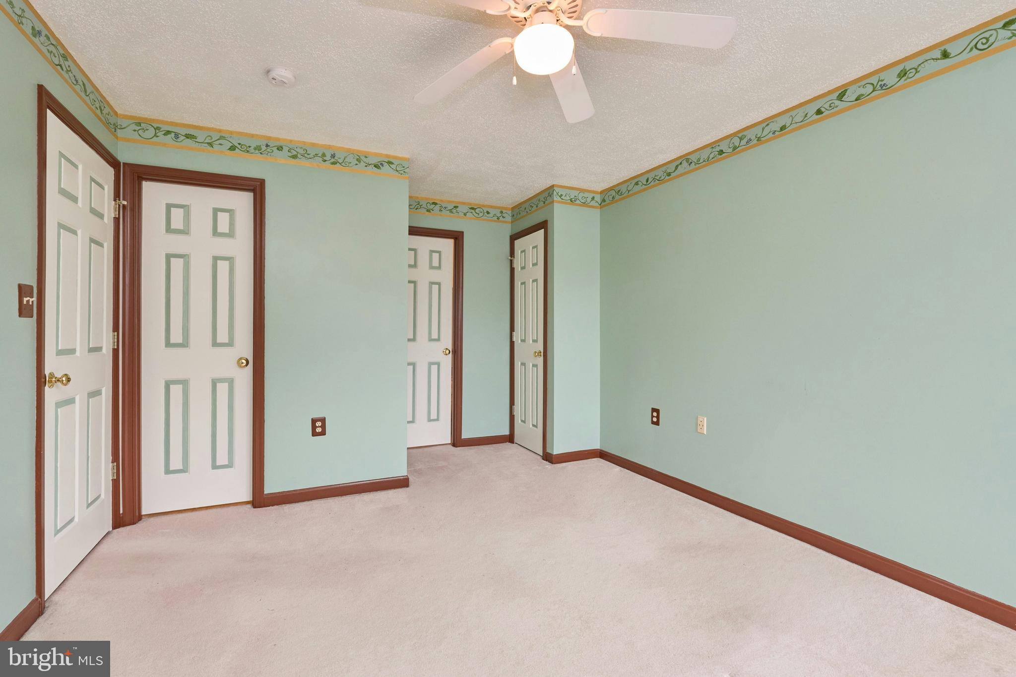 21014 Timber Ridge Terrace, Unit 302 Ashburn, VA 20147 - Photo 26 of 32 a view of an empty room with a chandelier fan