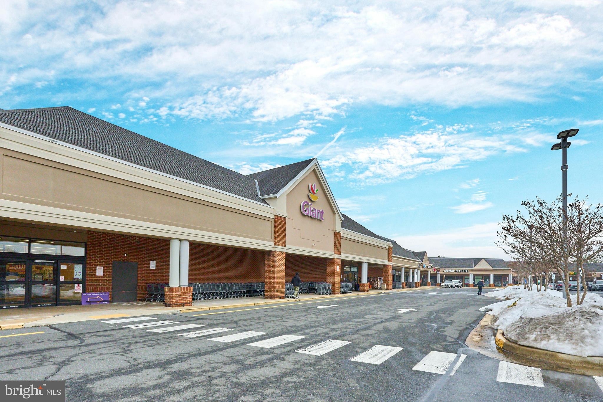 21014 Timber Ridge Terrace, Unit 302 Ashburn, VA 20147 - Photo 31 of 32 a front view of a house with garden