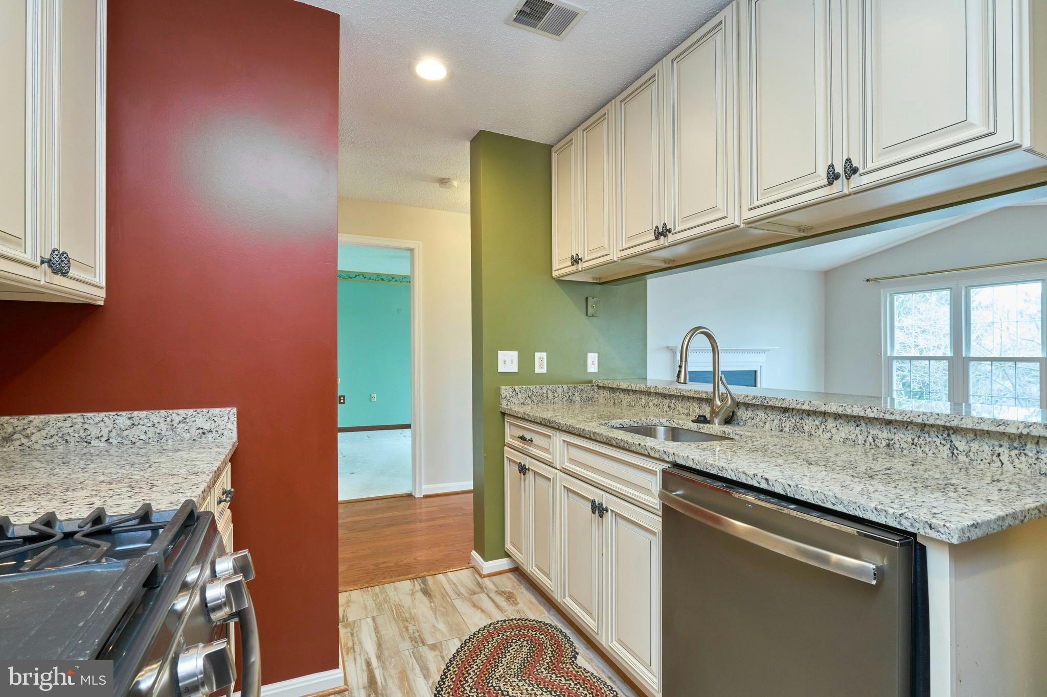 21014 Timber Ridge Terrace, Unit 302 Ashburn, VA 20147 - Photo 4 of 32 a kitchen with stainless steel appliances granite countertop a sink stove and cabinets