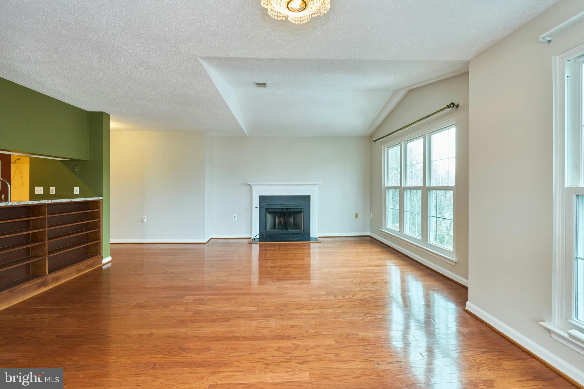 21014 Timber Ridge Terrace, Unit 302 Ashburn, VA 20147 - Photo 7 of 32 a view of an empty room with window and wooden floor