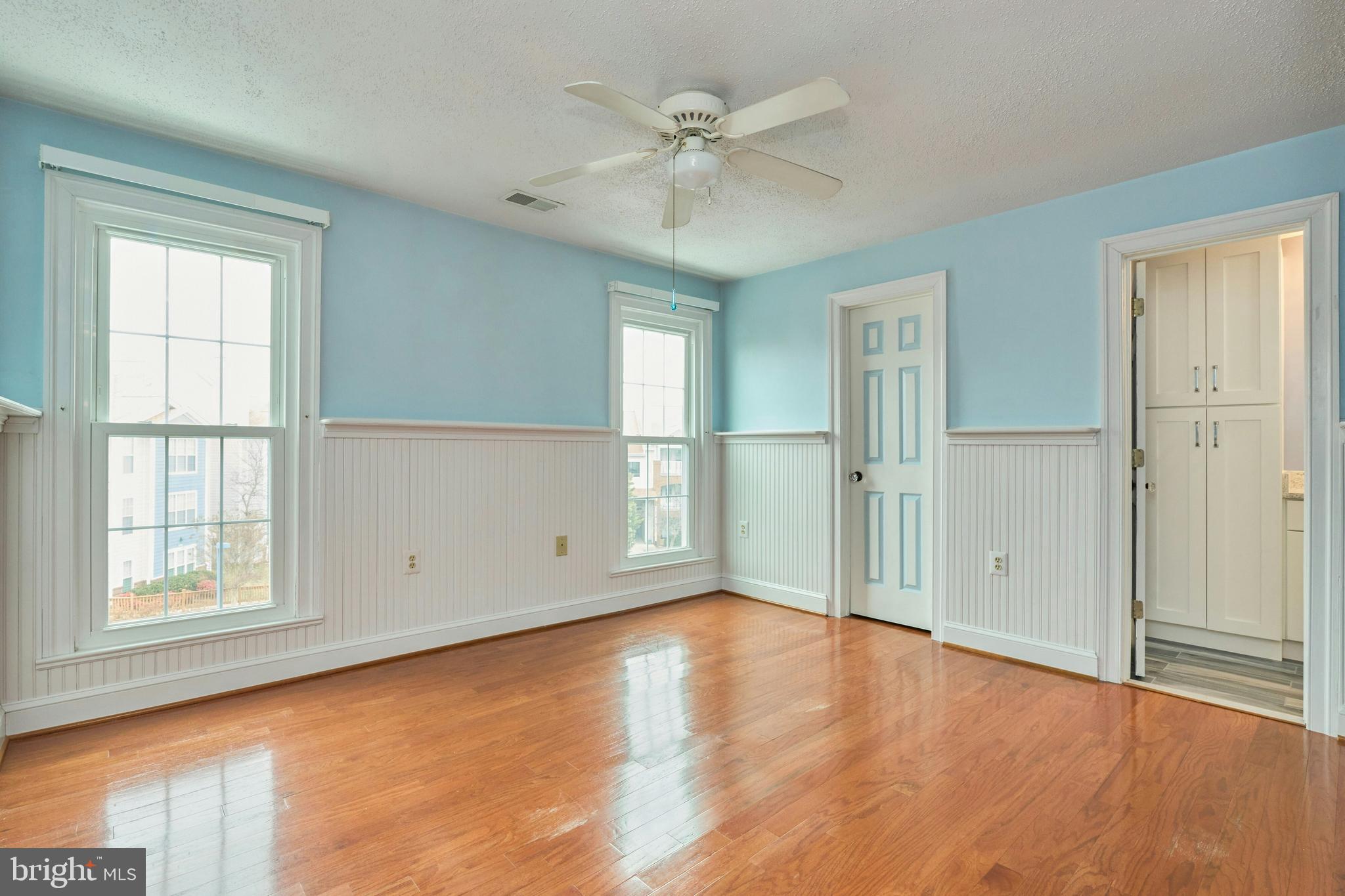 21014 Timber Ridge Terrace, Unit 302 Ashburn, VA 20147 - Photo 9 of 32 wooden floor in an empty room with a window