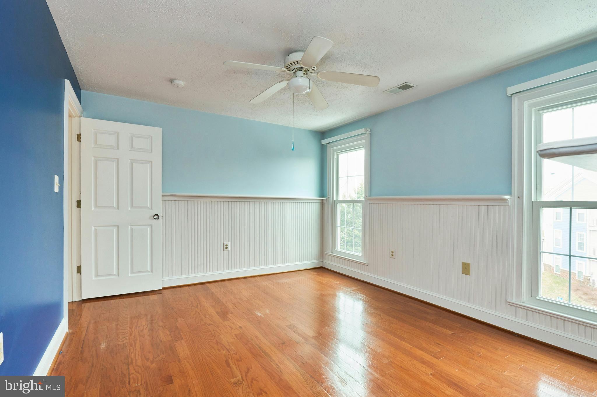21014 Timber Ridge Terrace, Unit 302 Ashburn, VA 20147 - Photo 10 of 32 wooden floor in an empty room with a window