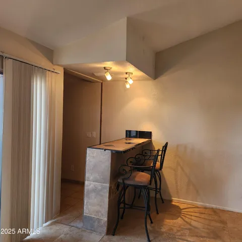 a view of a room with a table and chairs