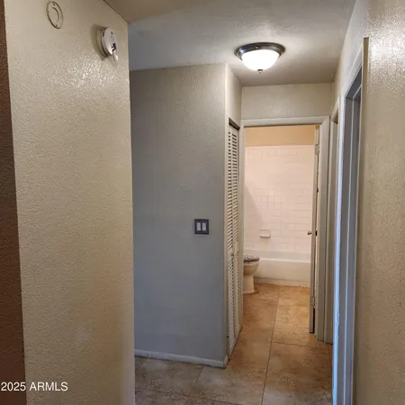 a bathroom with a granite countertop sink a toilet and a mirror