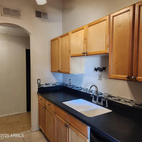a kitchen with a sink a stove and cabinets