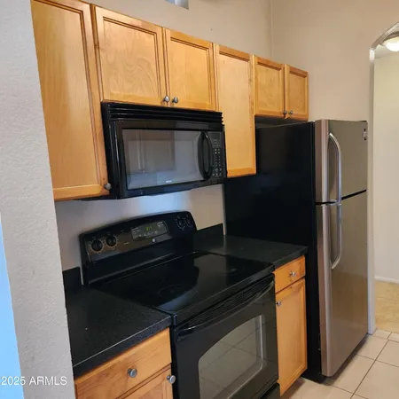 a kitchen with a refrigerator stove and microwave