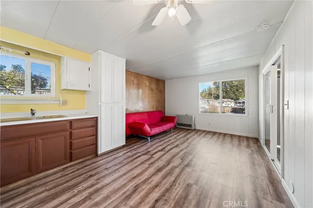 a living room with furniture pool table and stainless steel appliances