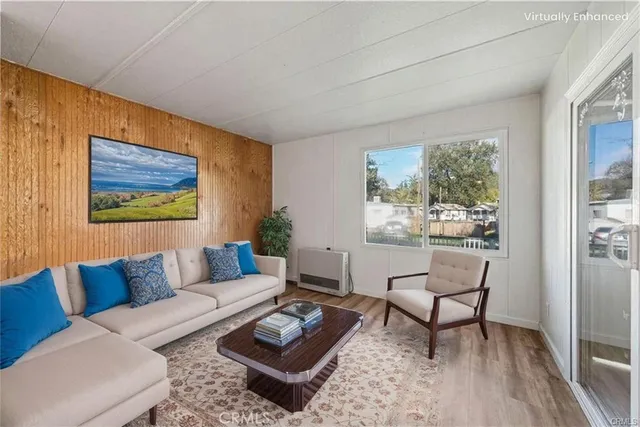 a view of a kitchen with wooden floor and a refrigerator