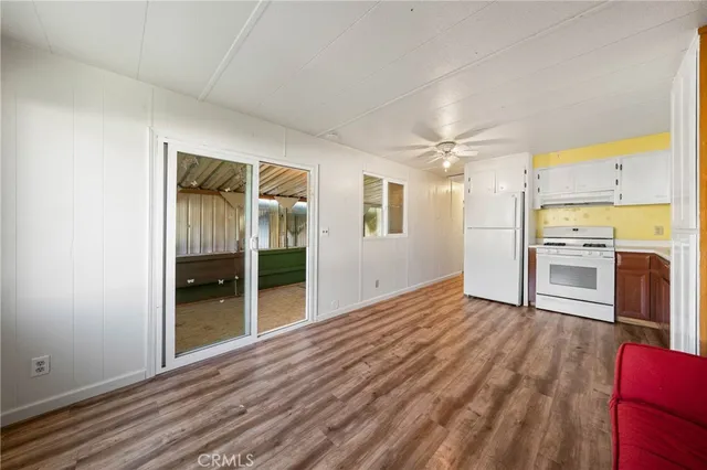a kitchen with a refrigerator sink and cabinets