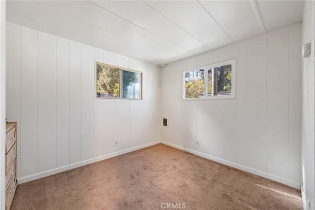 a bedroom with a bed and a potted plant